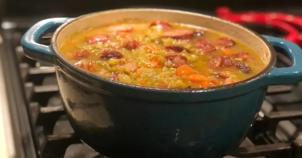 Warm pot of smokey split pea soup with sausage simmering in my teal pot on the stove