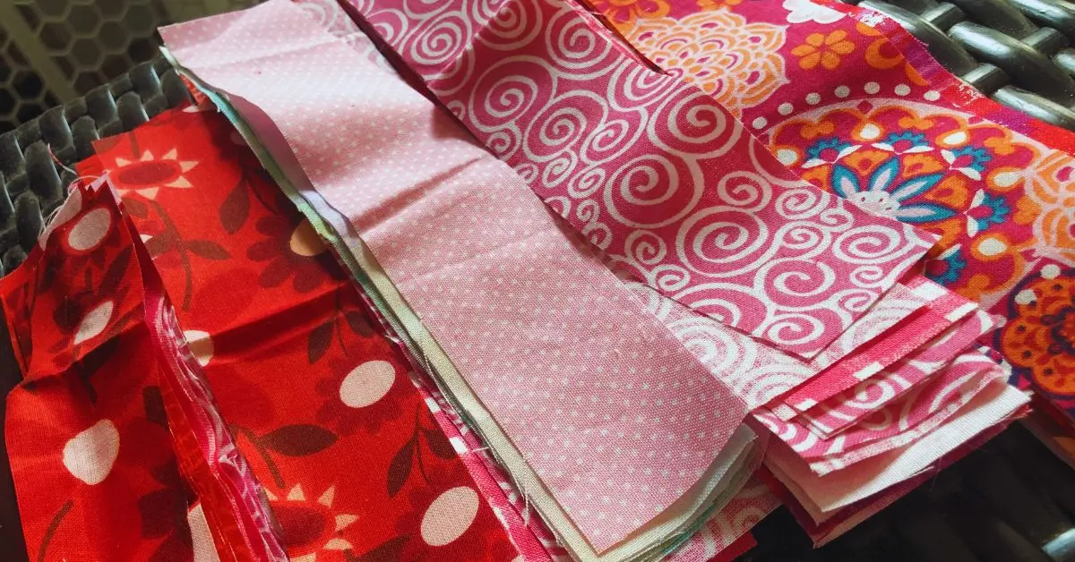 strips of cotton fabric with different hues of reds and pinks