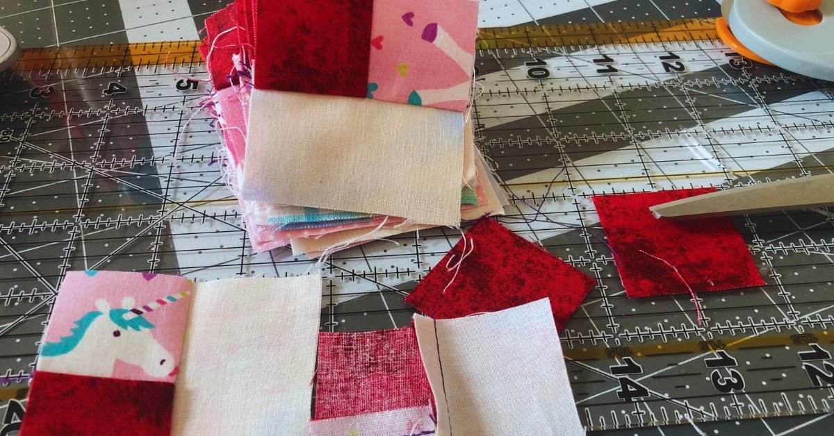 The beginnings of the log cabin quilt block with the center of the block.