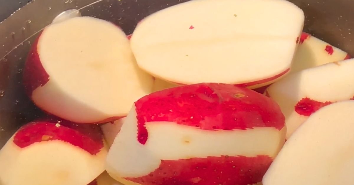 Cut red potatoes soaking in water before cooking for mashed potatoes
