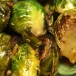 Close-up of pan-seared fresh Brussels sprouts with garlic and olive oil, golden brown edges and tender inside