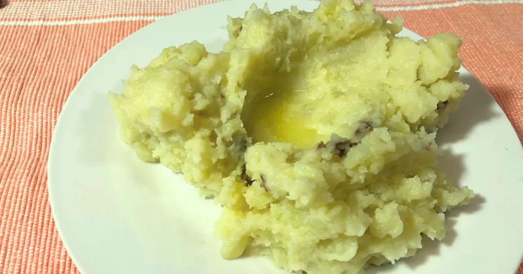 Rustic red skinned mashed potatoes with creamy texture and potato skin