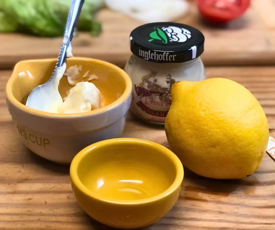 Horseradish mayo ingredients with fresh lemon and prepared horseradish