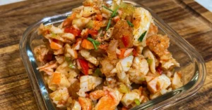 Cajun Seafood salad featuring shrimp and crab, without mayo, served in a glass bowl