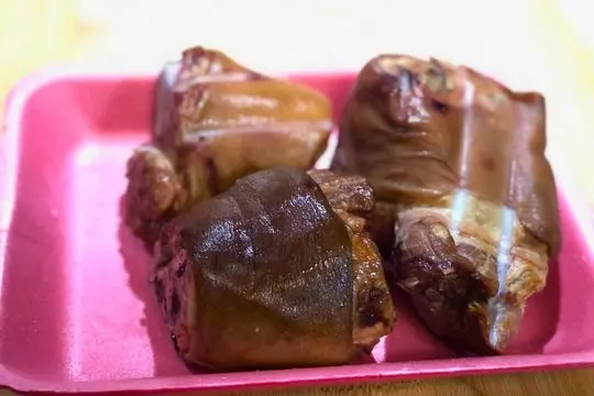 Three smoked ham hocks on a styrofoam tray for country succotash recipe