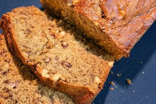 A top-down view of freshly baked banana bread, highlighting the golden, cracked crust and the rich texture of the slices.