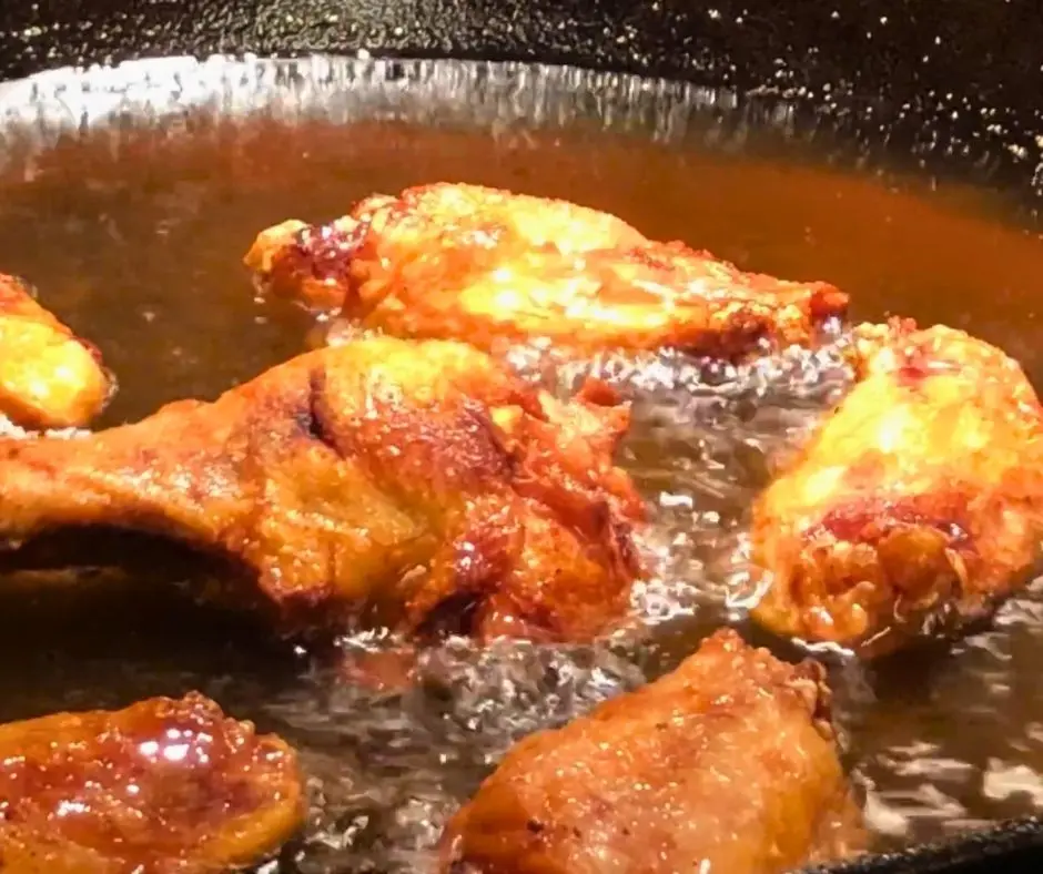 Naked chicken wings frying until golden and crispy