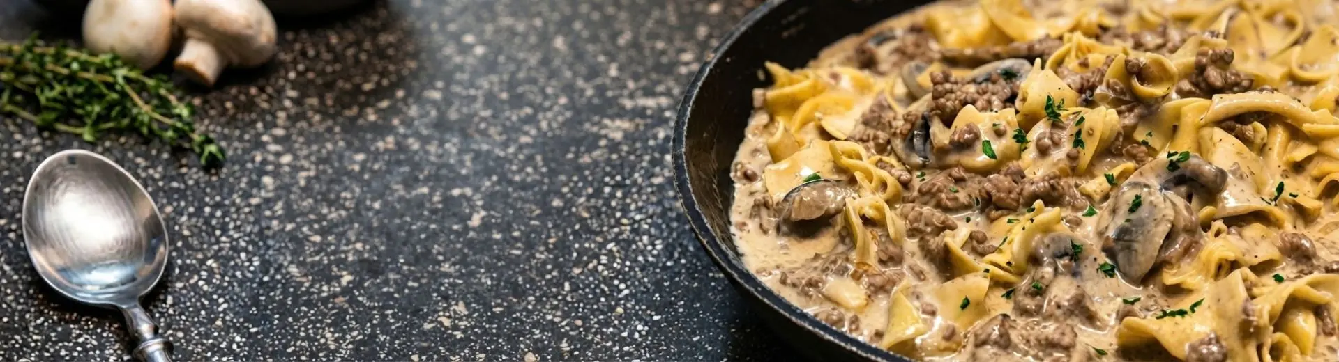 Creamy ground beef and mushroom noodles in a skillet