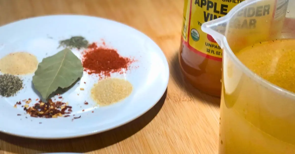 Seasonings, chicken broth, and apple cider vinegar for meatless collard greens