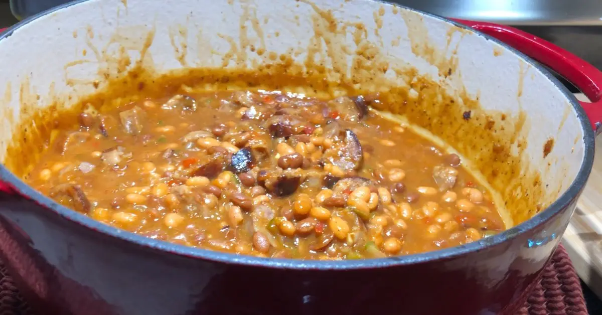 Beanie weenies with sliced sausage in a Dutch oven